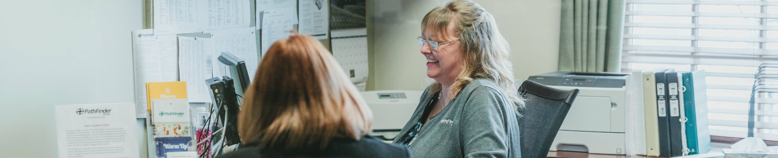 Employee at Meridian Financial Trust Bank helping a customer in their office